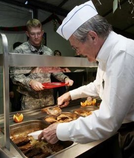 Secretary of Defense Rumsfeld serves Christmas dinner in Mosul
